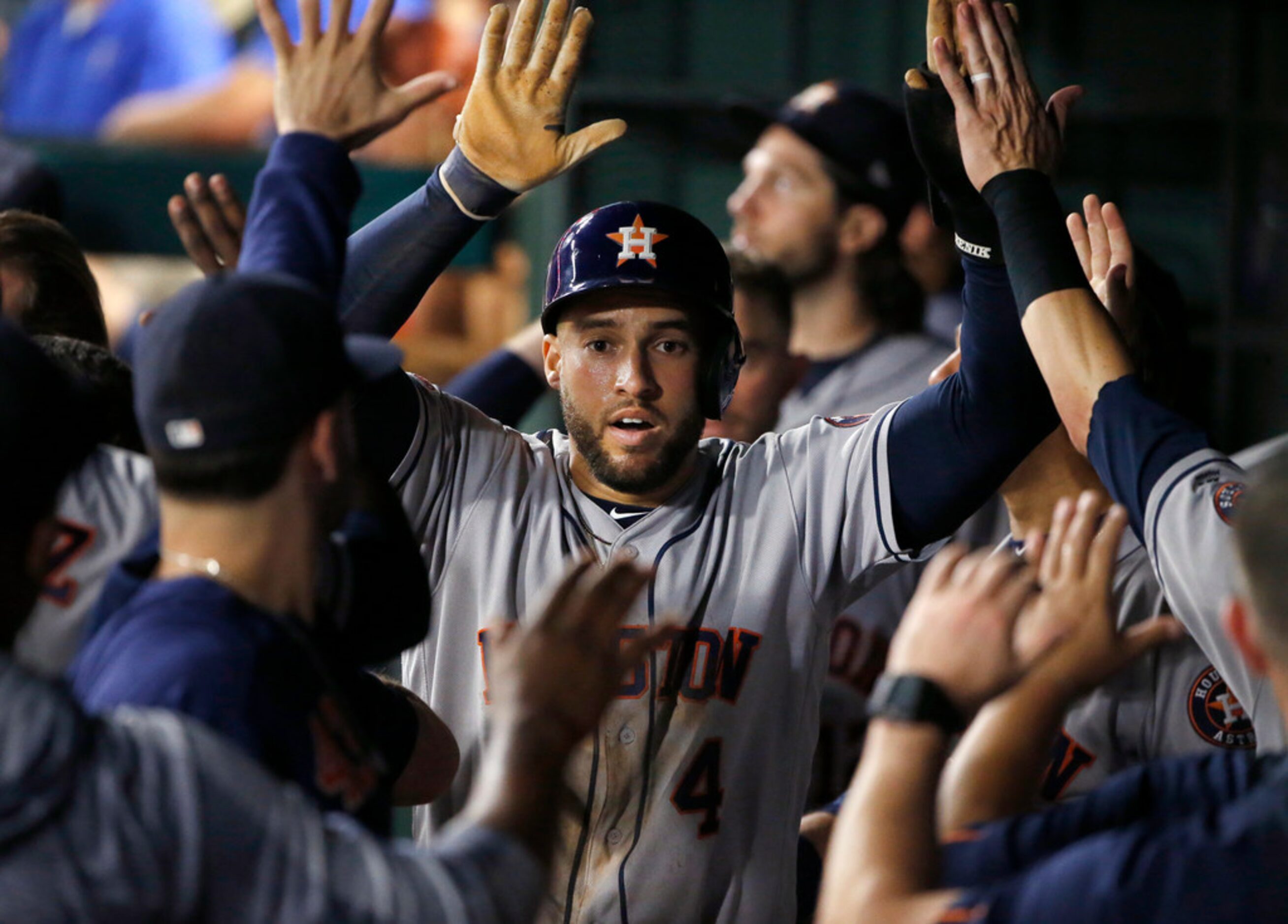 Houston Astros center fielder George Springer (4) is congratulated by teammates after...