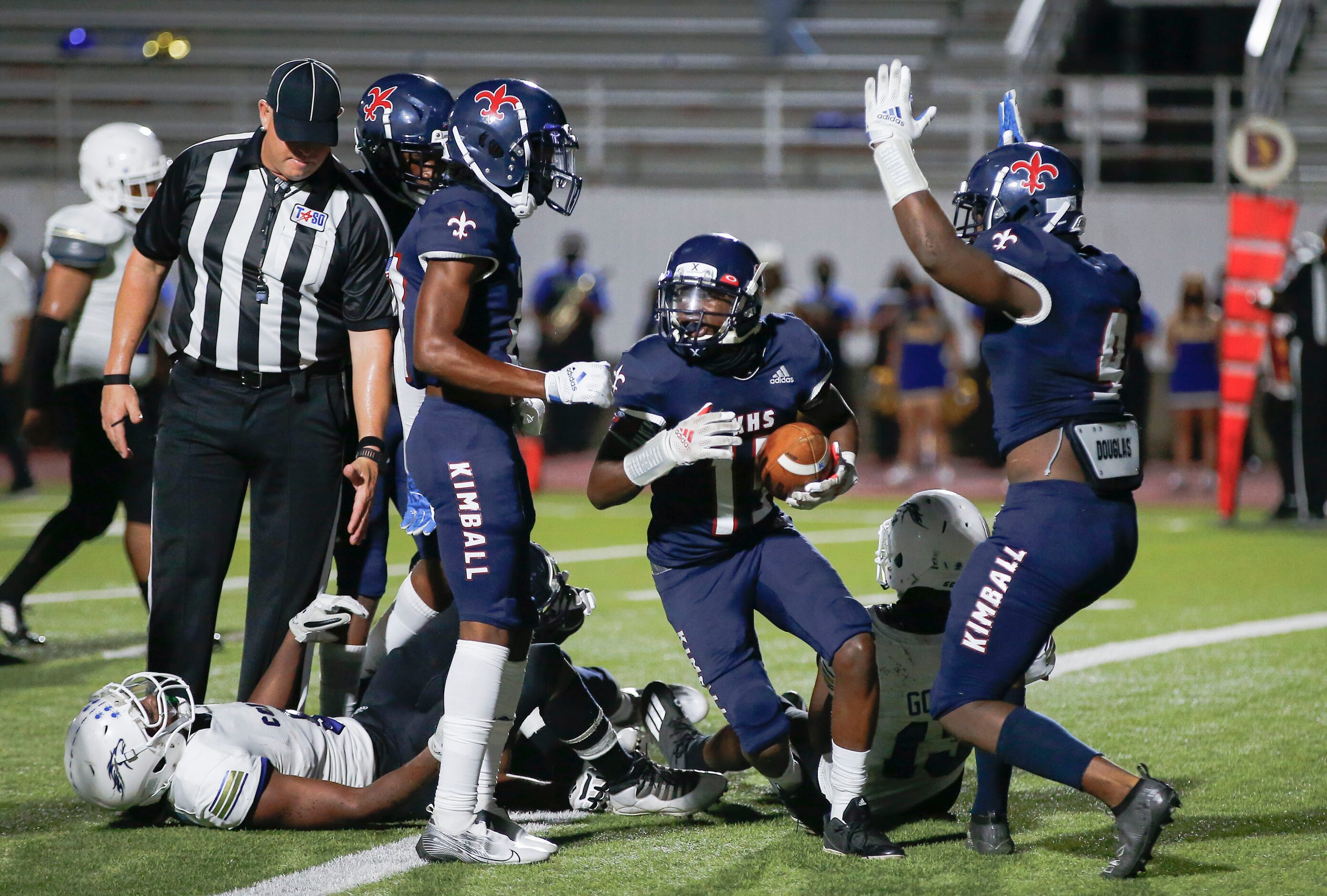 Kimball junior wide receiver Cedric Robertson, center, is congratulated by teammates after...