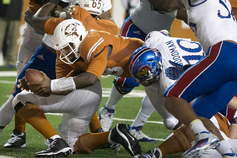 Texas' Tyrone Swoopes dives over the goal line for a touchdown during the first quarter...
