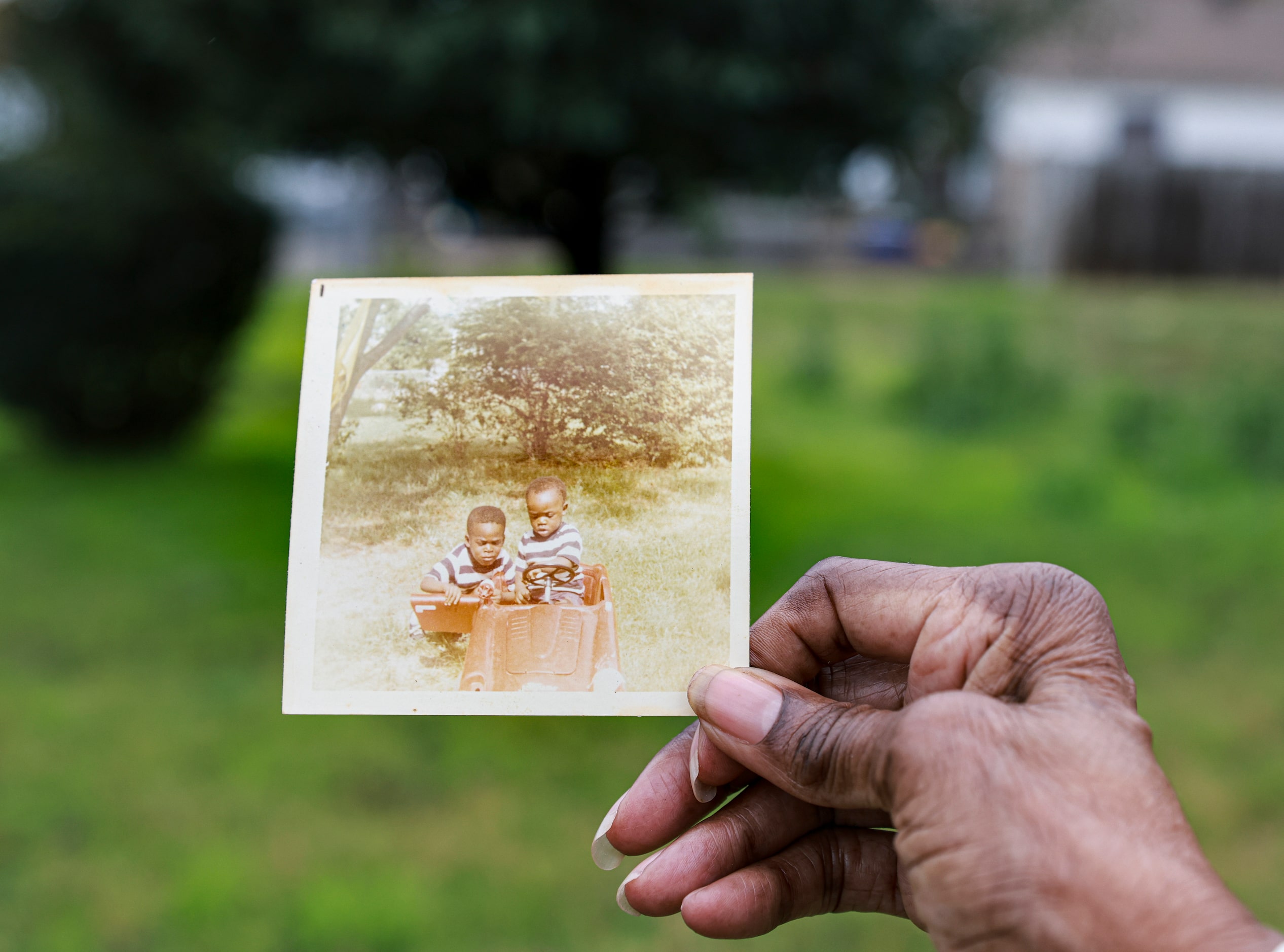 Gloria Johnson holds up a photo of where her two now-deceased sons, British Don and Gilbert...