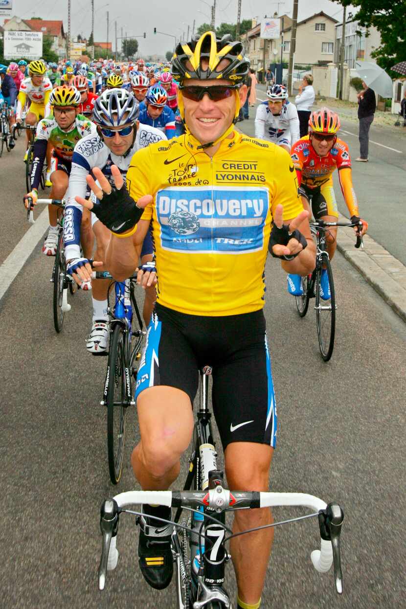 Overall leader Lance Armstrong signals seven for his seventh straight win in the Tour de...