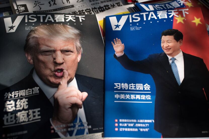 Magazines featuring front pages of US President Donald Trump (L) and China's President Xi...