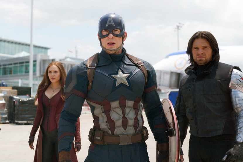 This image released by Disney shows Elizabeth Olsen, left, Chris Evans and Sebastian Stan in...