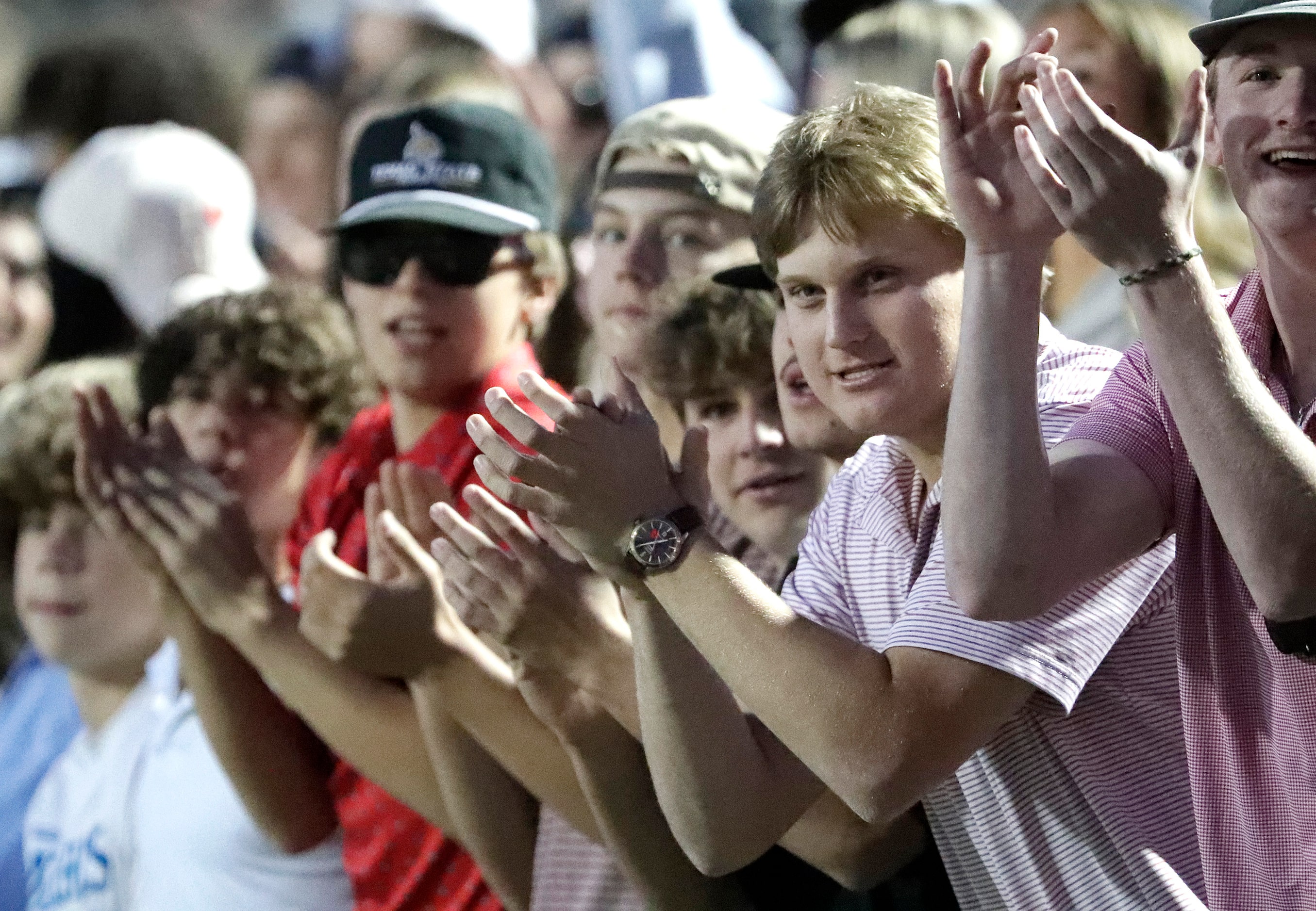 The Allen High School student section applauds their first touchdown of the game during the...