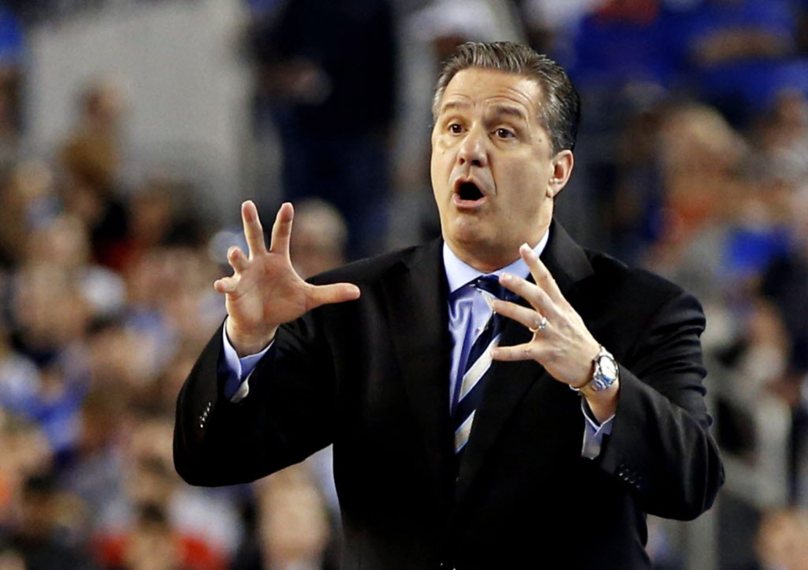 Kentucky Wildcats head coach John Calipari calls to players during the first half of their...