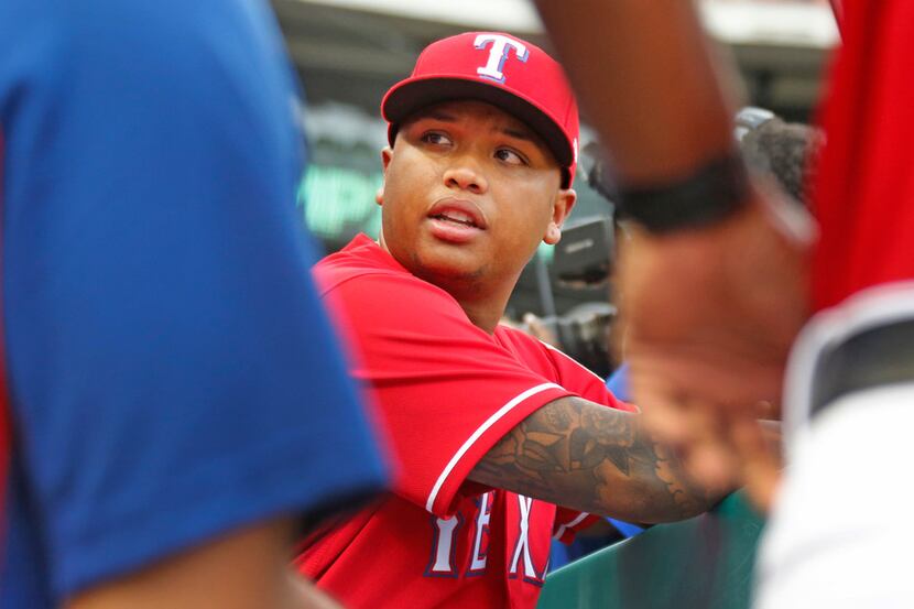 Texas Rangers designated hitter Willie Calhoun (5) is pictured in the dugout before the...