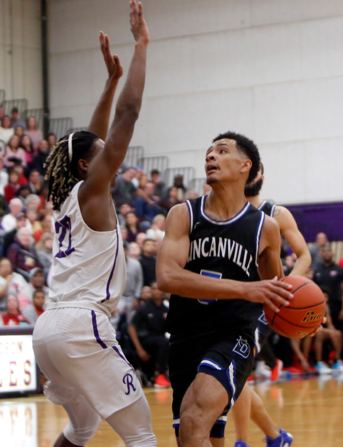 Duncanville's Micah Peavy (5) drives to the basket against the defense of Richardson's Cason...