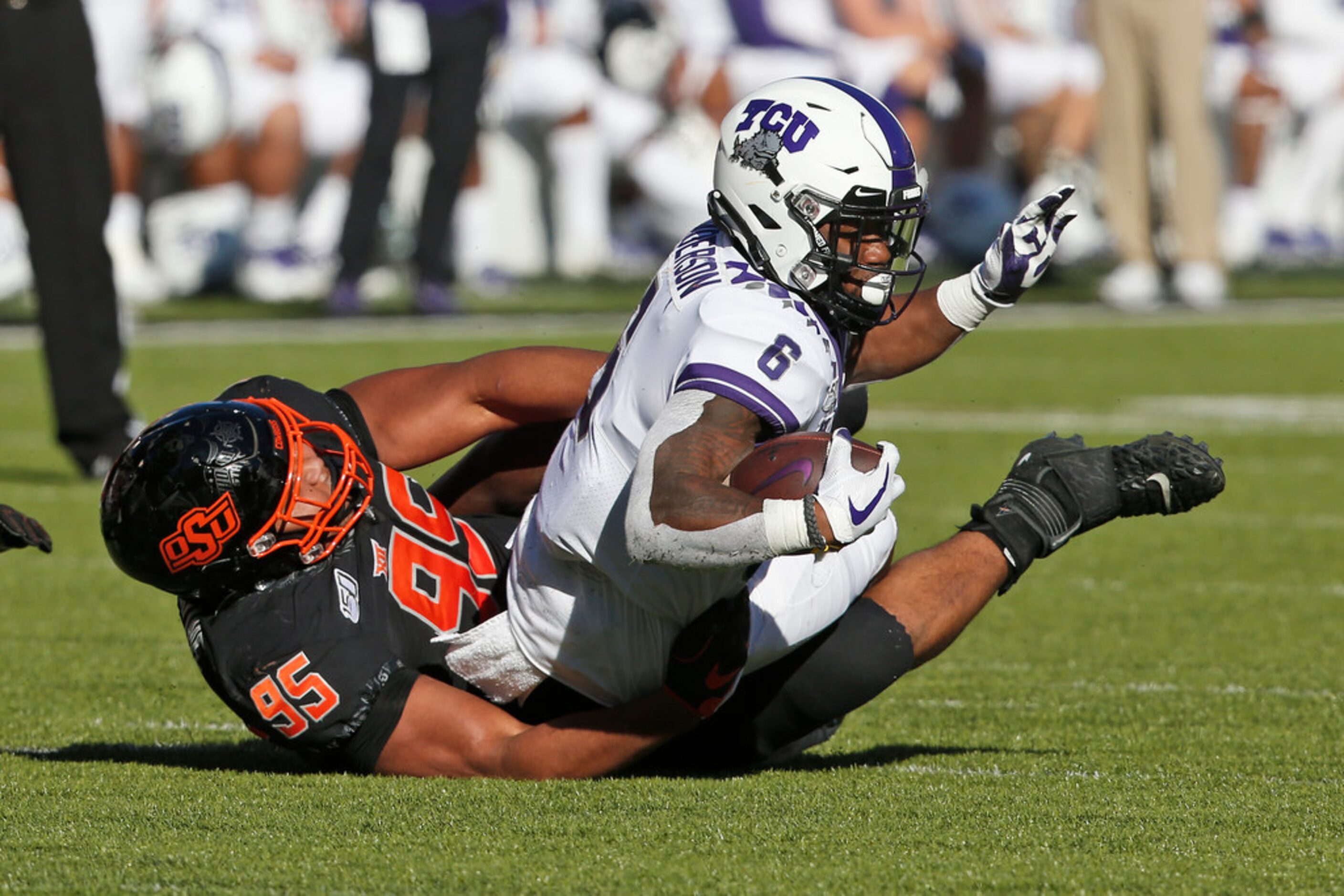 Oklahoma State defensive tackle Israel Antwine (95) tackles TCU running back Darius Anderson...