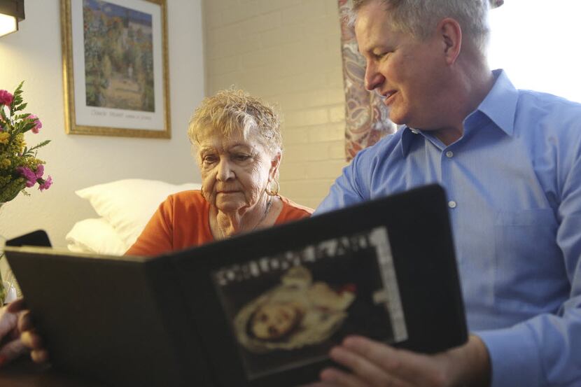 At a nursing home in Irving in 2012, a volunteer showed a digital art book to a resident. It...