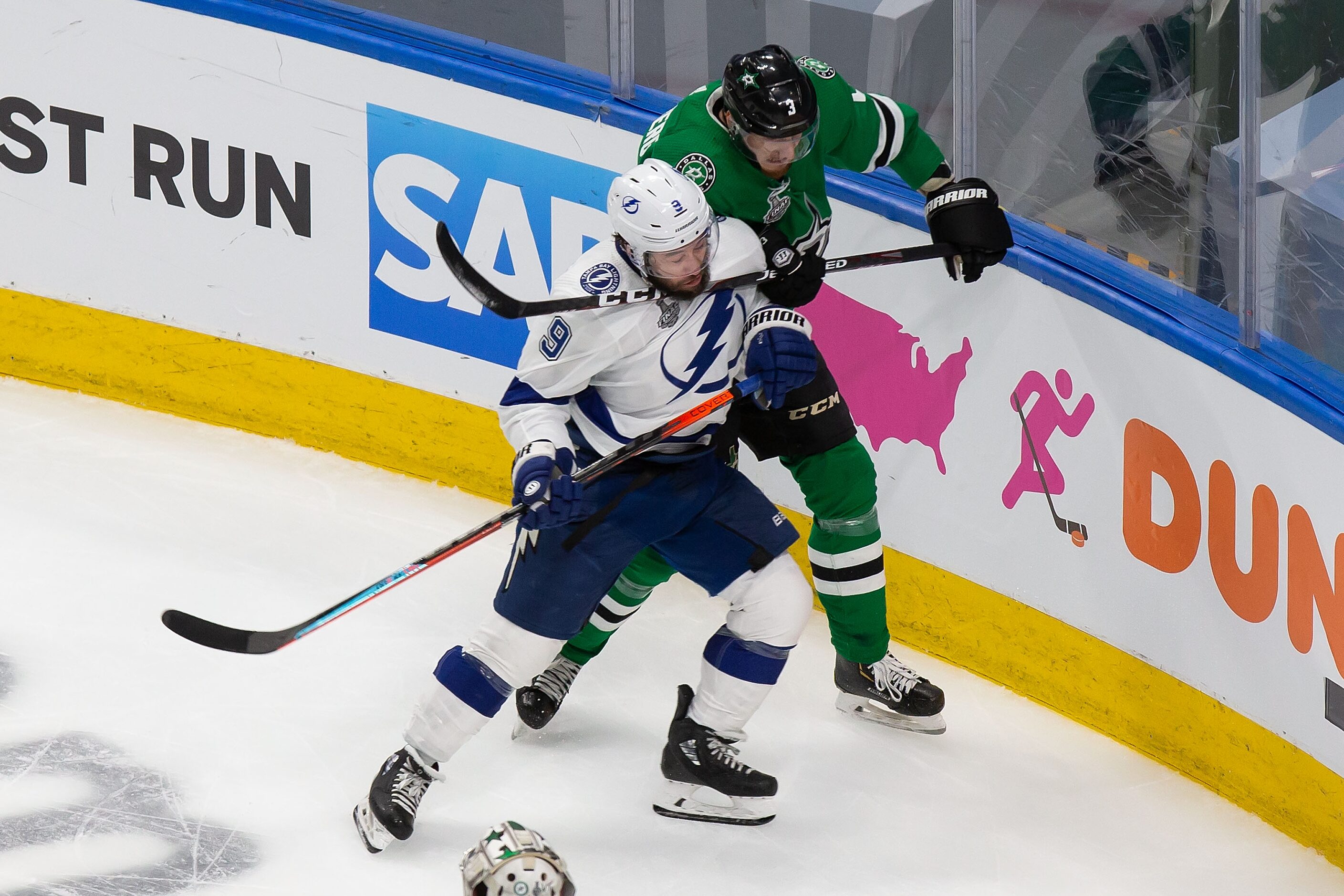 John Klingberg (3) of the Dallas Stars battles against Tyler Johnson (9) of the Tampa Bay...