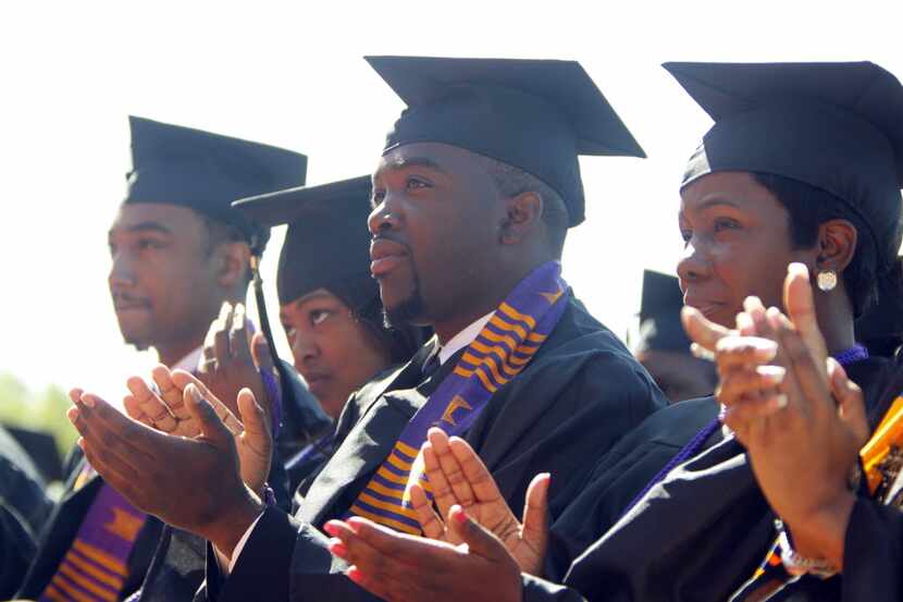 Graduates clap during a Paul Quinn College graduation ceremony in 2013.
