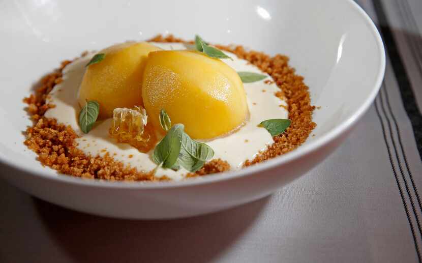 Peaches and Cream dessert at Kitchen LTO, made with bourbon-soaked Cooper Farms peaches,...