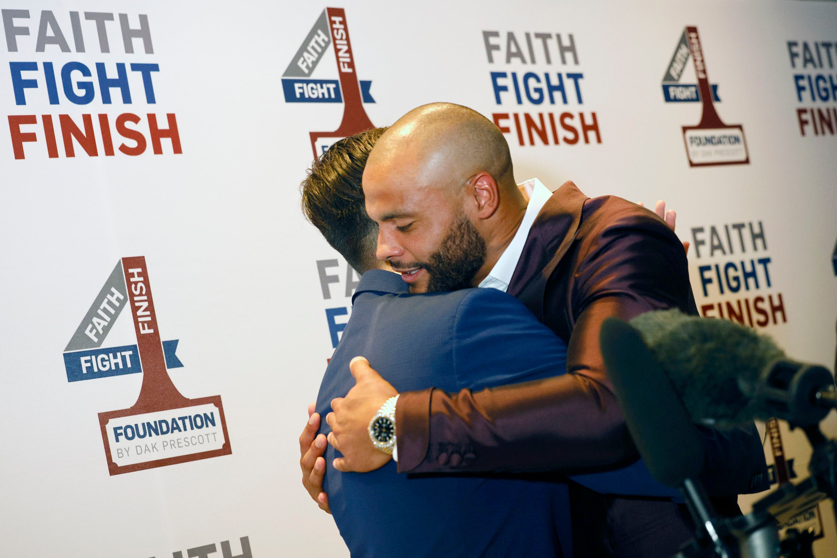 Dallas Cowboys quarterback Dak Prescott hugs NFL International Fan of the Year Eduardo...