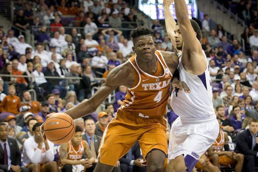 Texas' Mohamed Bamba, left, moves past Texas Christian's Kenrich Williams in the second half...