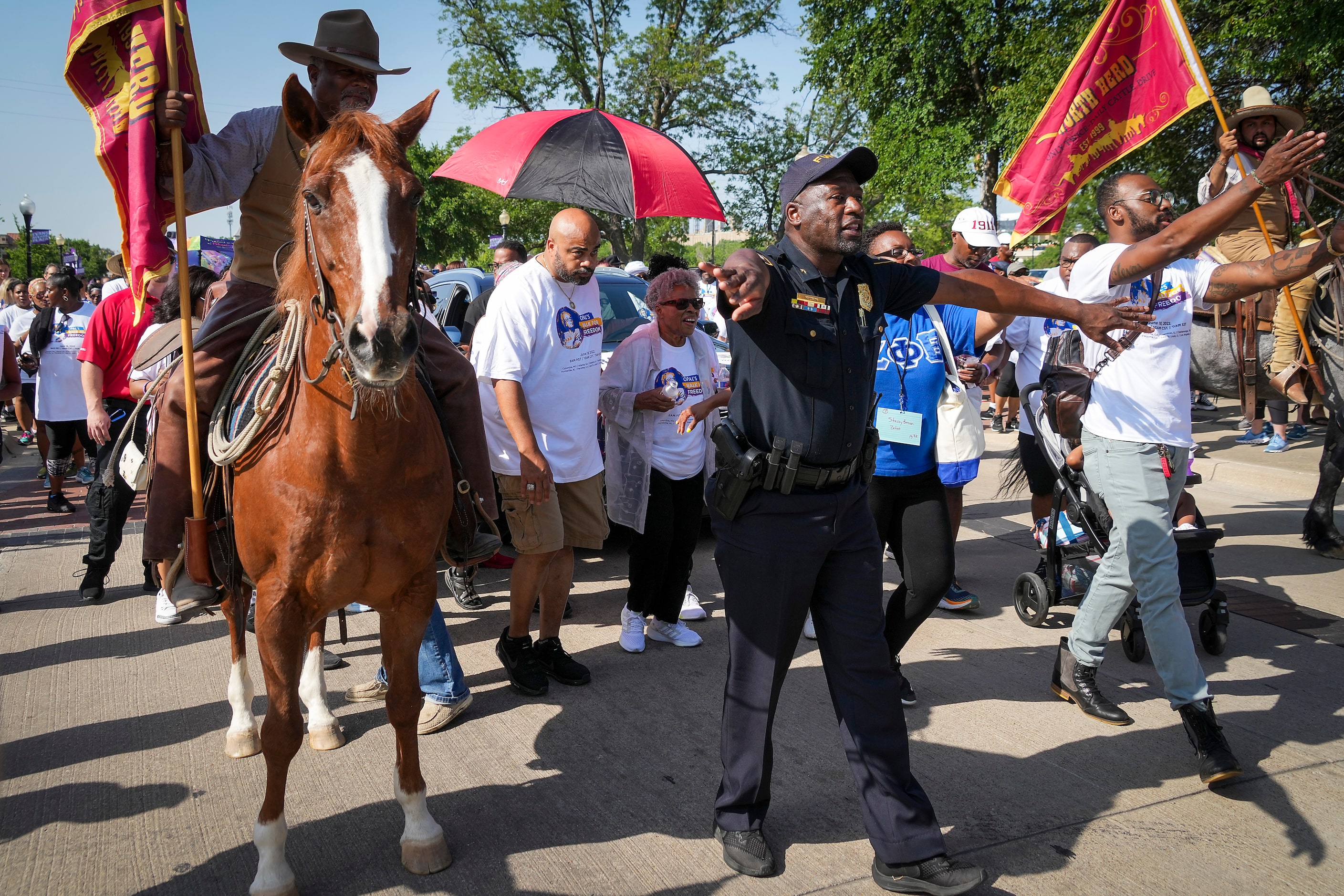 Officials clear the way for Opal Lee to begin the 2022 Opal's Walk for Freedom on Saturday,...