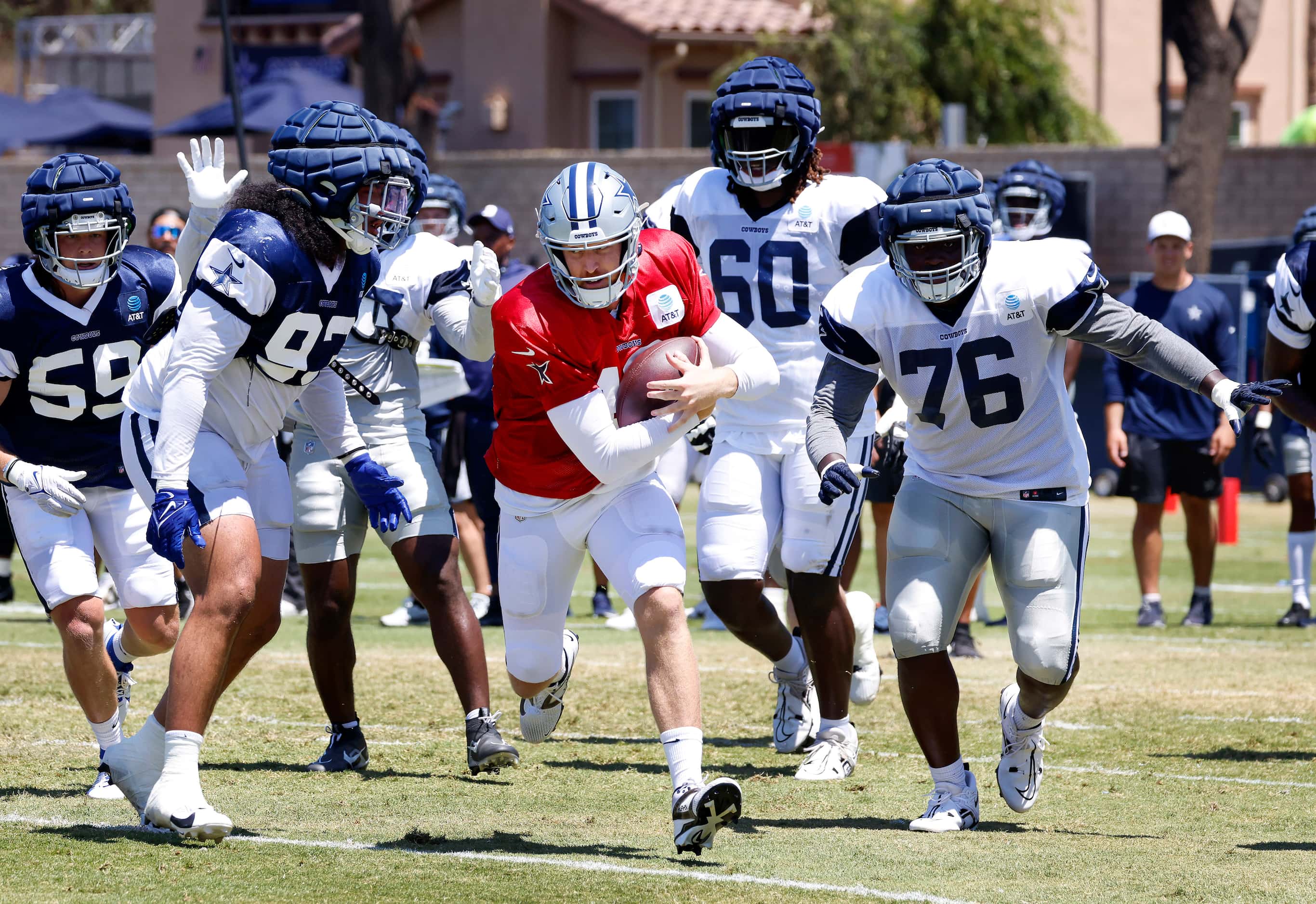 Dallas Cowboys quarterback Cooper Rush (10) keeps the ball and runs against the defense...