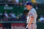Texas Rangers pitcher Josh Sborz walks off the field with an injury during the sixth inning...