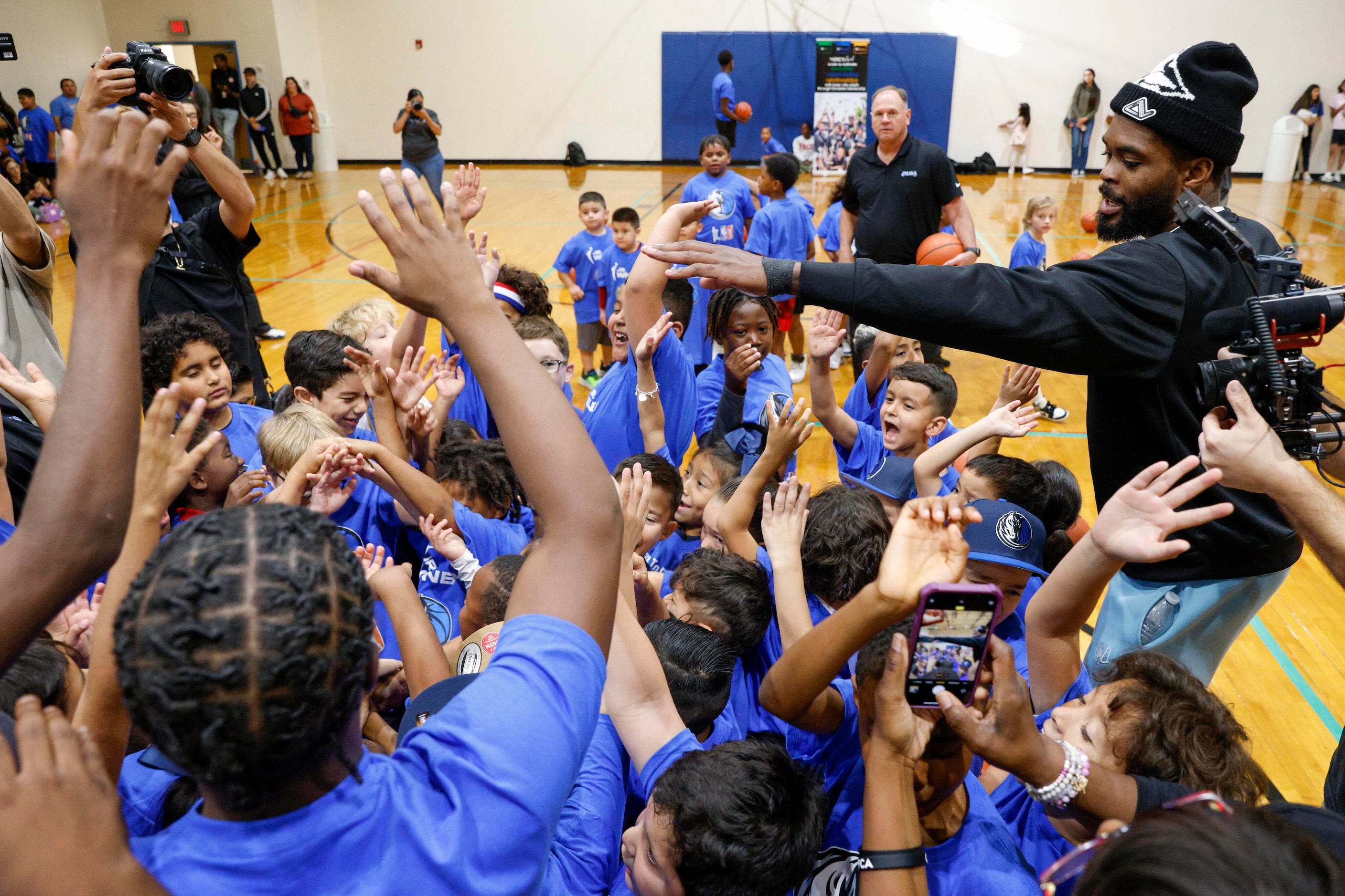 Dallas Mavericks forward Naji Marshall breaks a huddle with kids during a children’s...