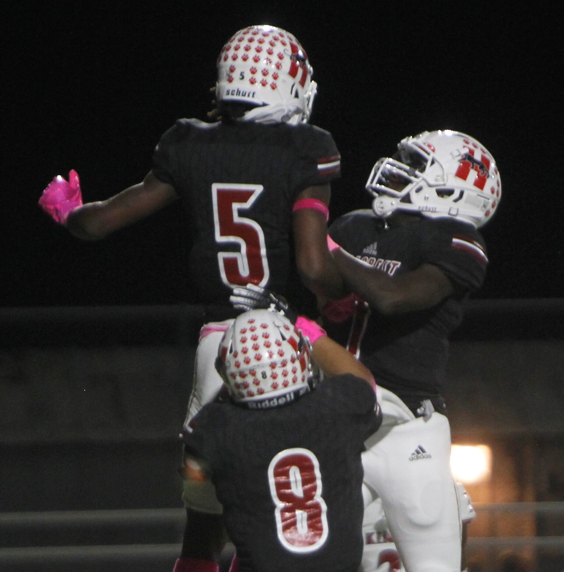 Dallas Hillcrest running back Shannon Cruse (5) leaps in celebration with quarterback Carter...