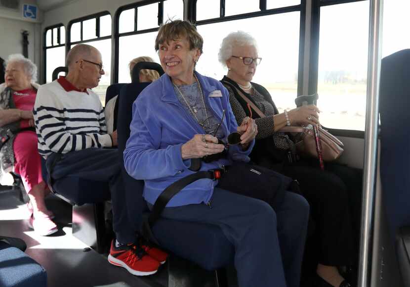 Joan Giles (left) sits next to Lorene Mathis as they wait for their Envoy America bus to...