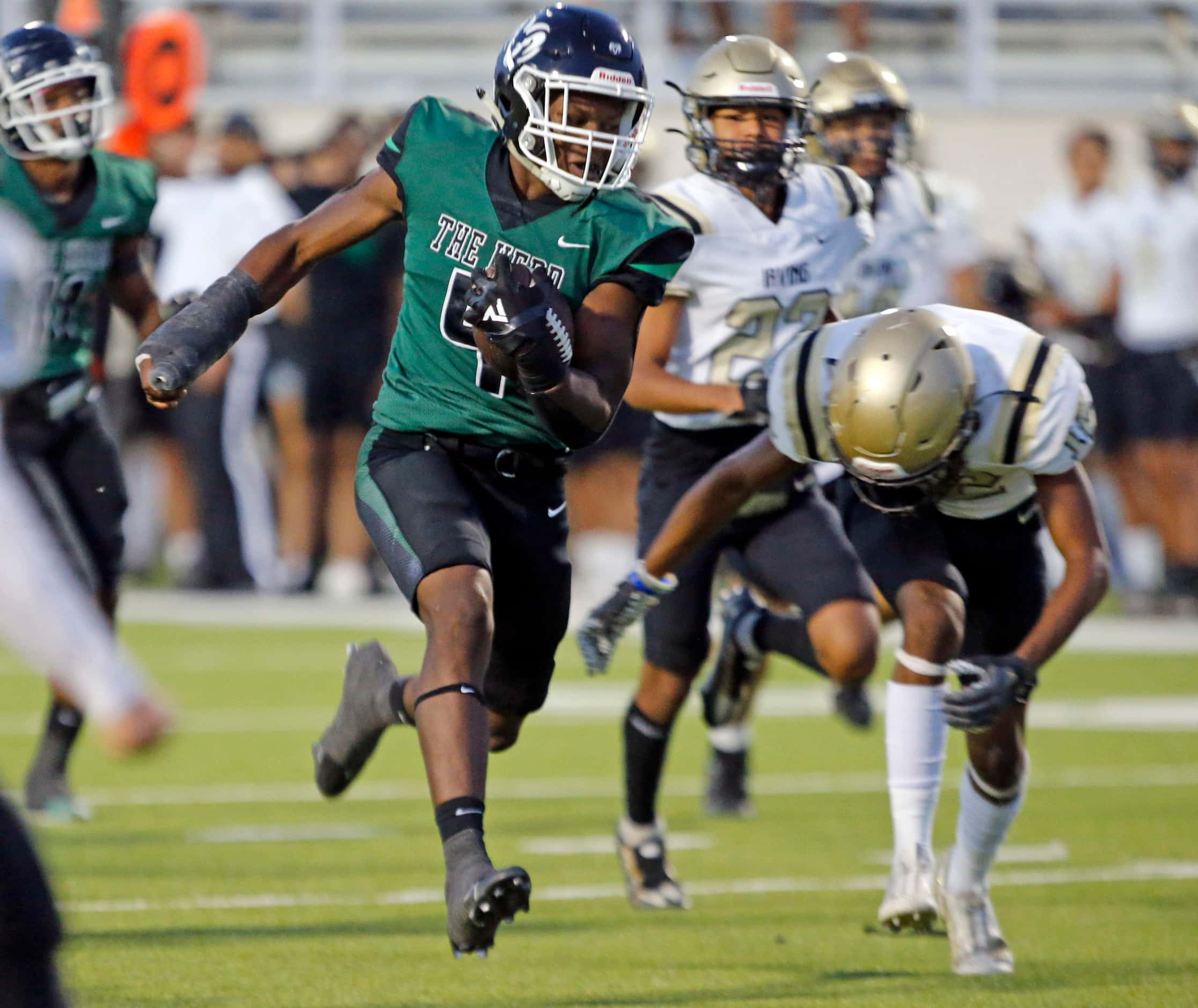Richardson Berkner high’s Jamary Williams (4) picks up a long first down during the first...