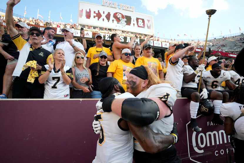 Appalachian State offensive lineman Bucky Williams, right, celebrates with Nate Noel, left,...