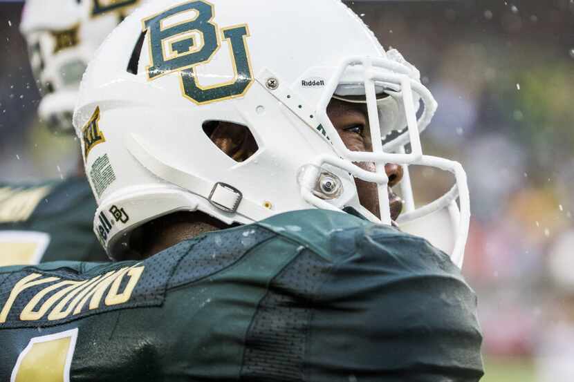 FILE - Baylor Bears linebacker Taylor Young (1) looks at the scoreboard through the rain...