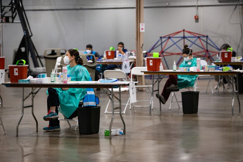 Staff waits to deliver COVID-19 vaccines at Fair Park in Dallas on Wednesday, Feb. 2, 2021.