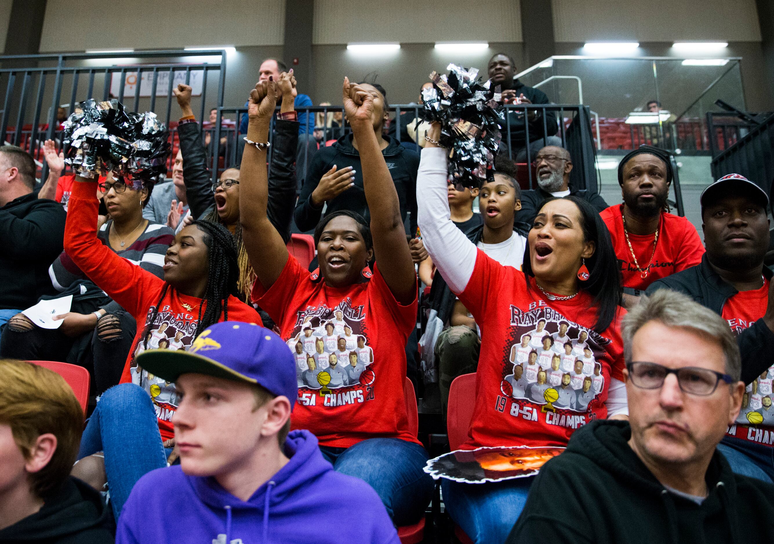 Denton Braswell fans cheer during the second quarter of a Class 5A area-round playoff boys...