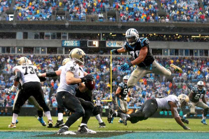 Greg Hardy pressures Saints quarterback Drew Brees. (Getty Images)