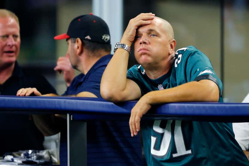 A Philadelphia Eagles fan reacts as his team lets the Dallas Cowboys back into the game in...