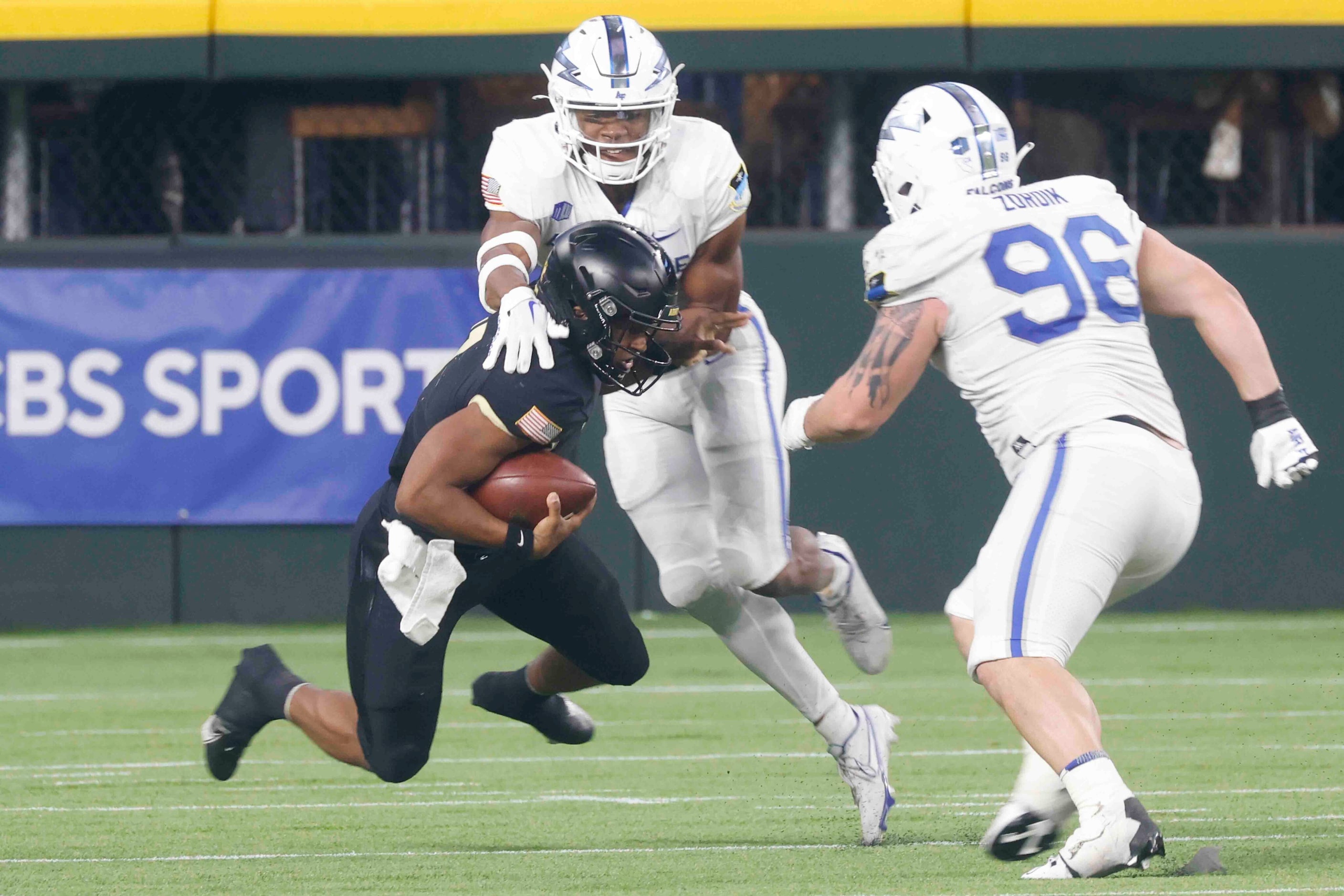 Army quarterback Jemel Jones (7), center, gets sacked by Air Force wide receiver David...