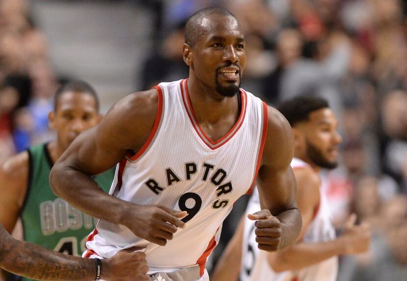 The Toronto Raptors' newest player, Serge Ibaka, reacts after making his first basket for...