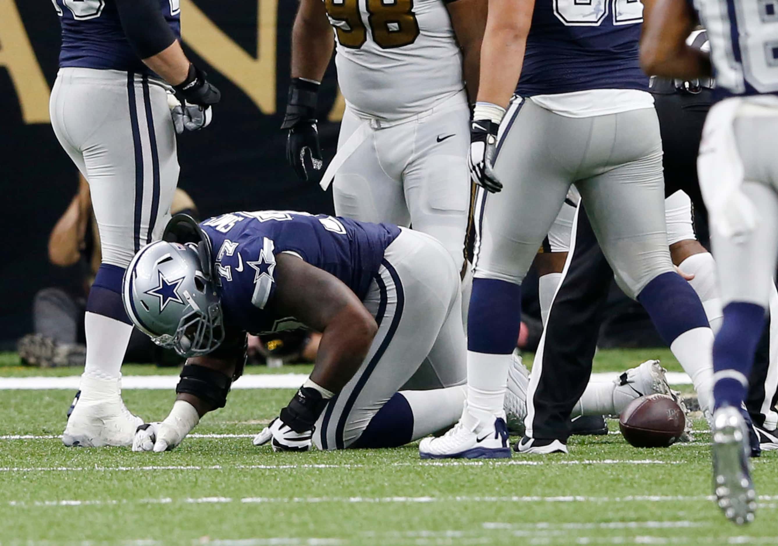 Dallas Cowboys offensive tackle Tyron Smith (77) is slow to get up after getting injured on...