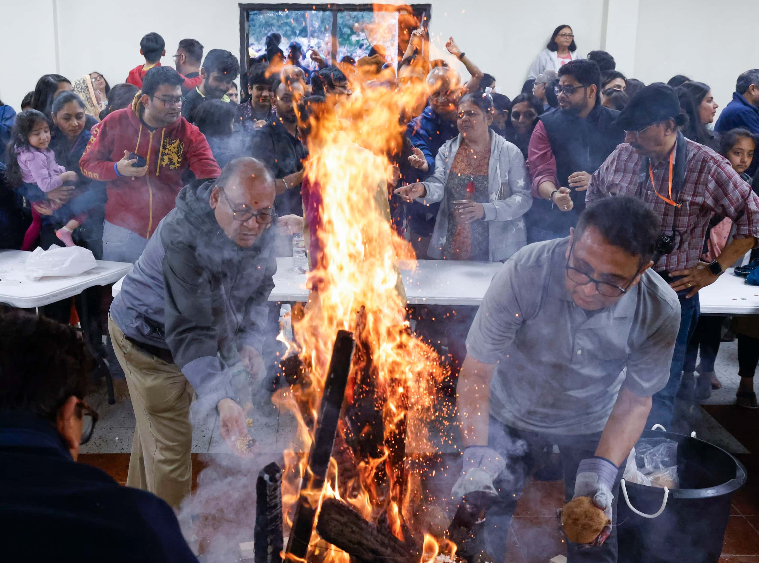 Hindu devotees perform Holika Dahan as part of the Holi festival celebrations on, Sunday,...