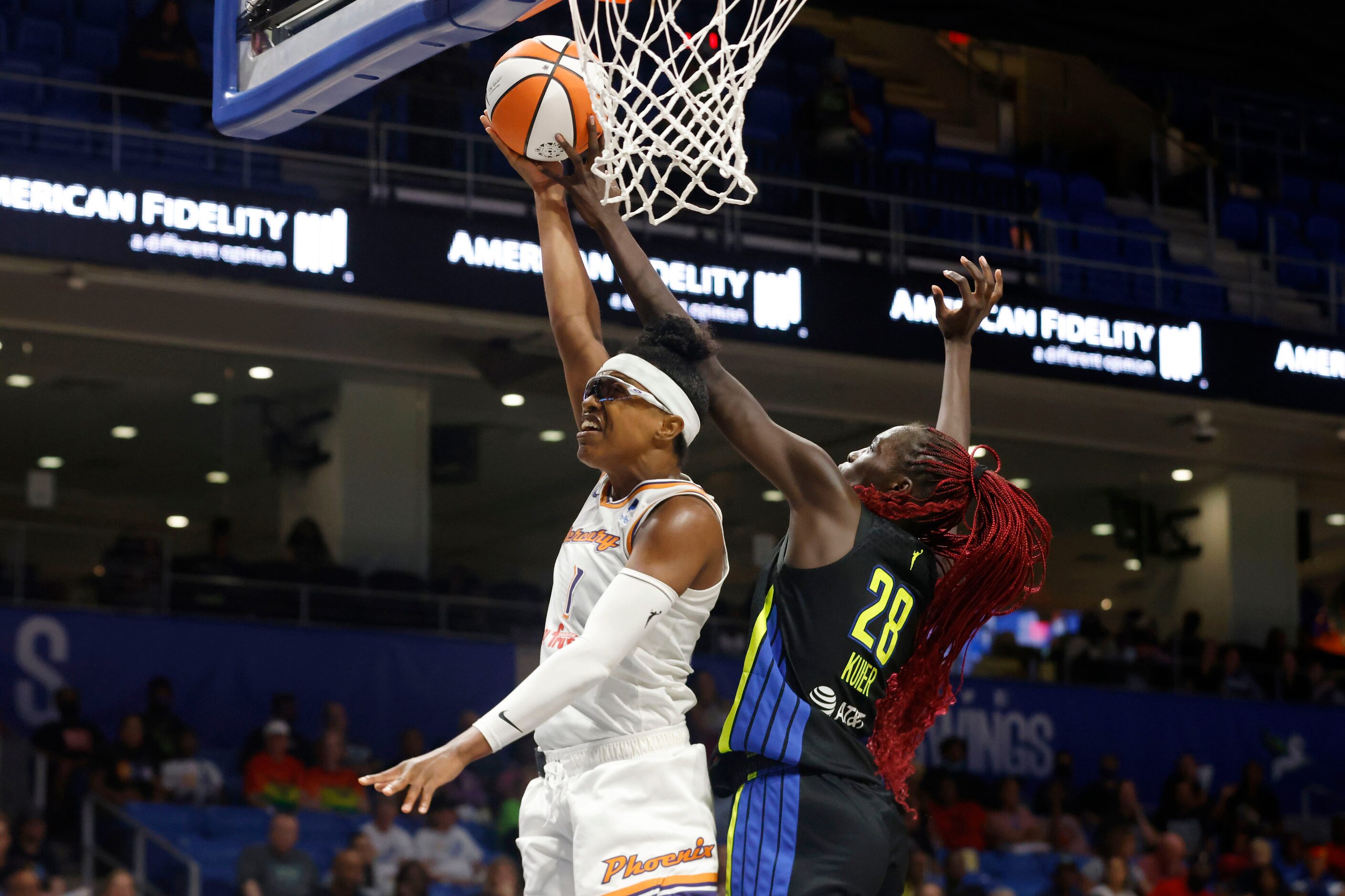 Phoenix Mercury guard Diamond DeShields (1) is fouled by Dallas Wings center Awak Kuier (28)...