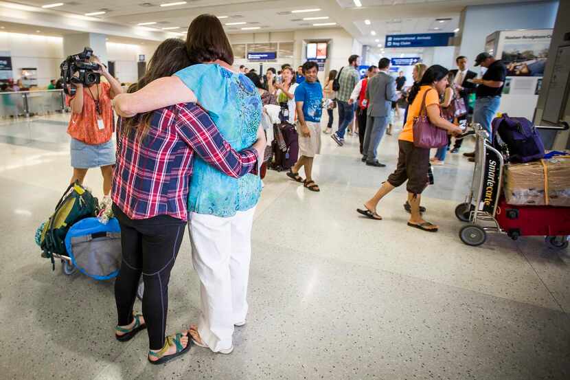 
Danielle Banks (left) gets a hug from her mother Sharon after returning from Nepal.
