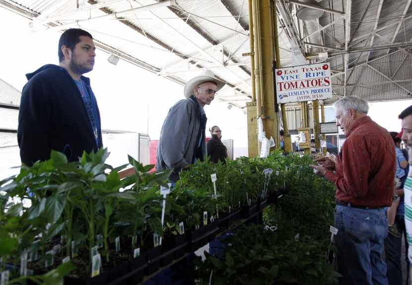 J.T. Lemley of Lemley's Farm, center top, assists customer Jerry Donoho, right, of Lancaster...