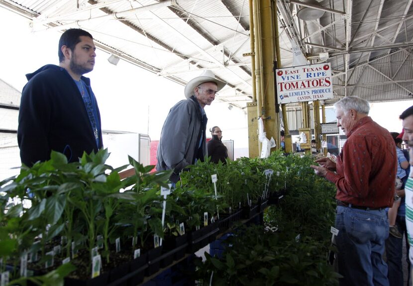 J.T. Lemley of Lemley's Farm, center top, assists customer Jerry Donoho, right, of Lancaster...