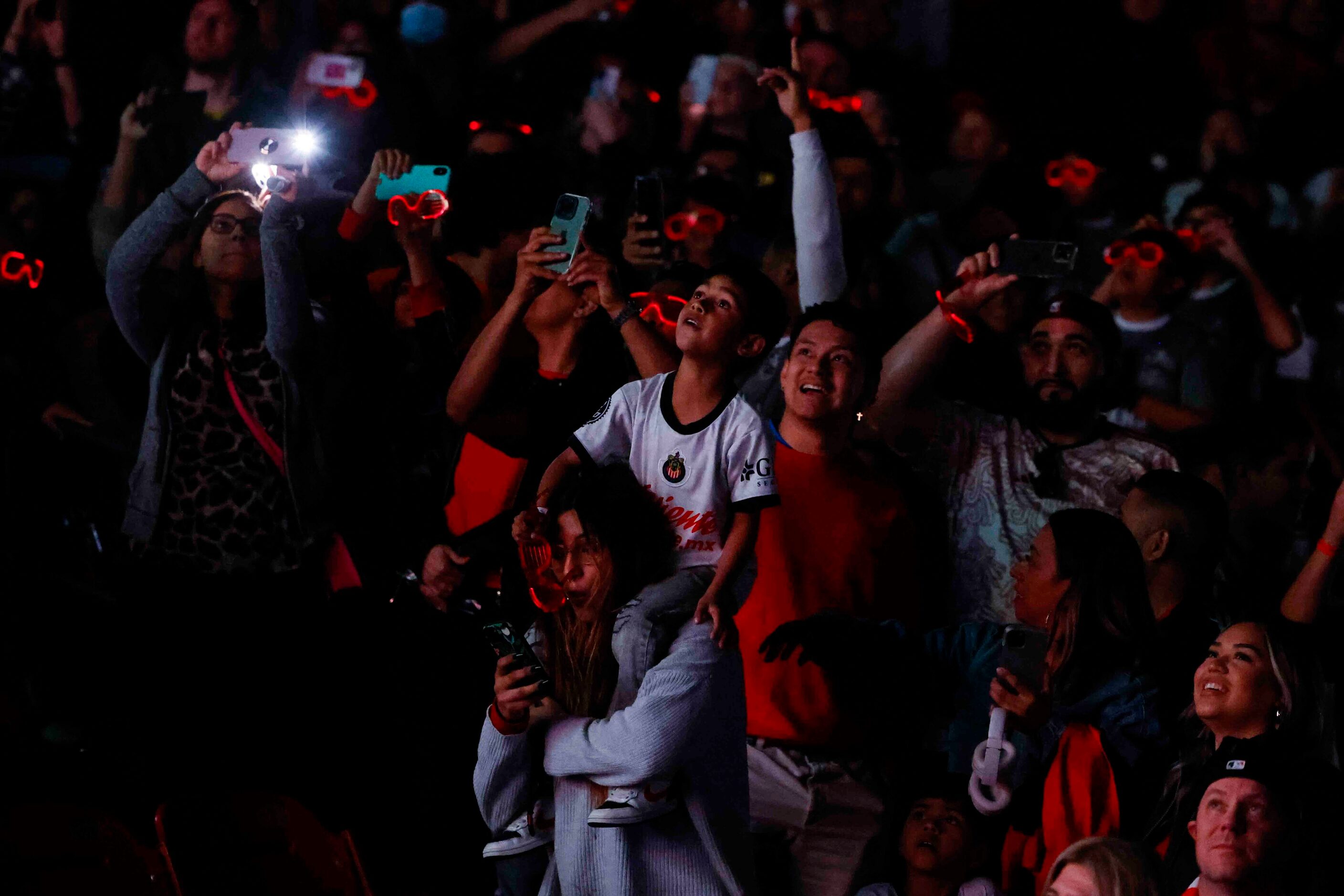 Crowd watches a live drone light show after an MLS soccer match on Saturday, March 4, 2023,...