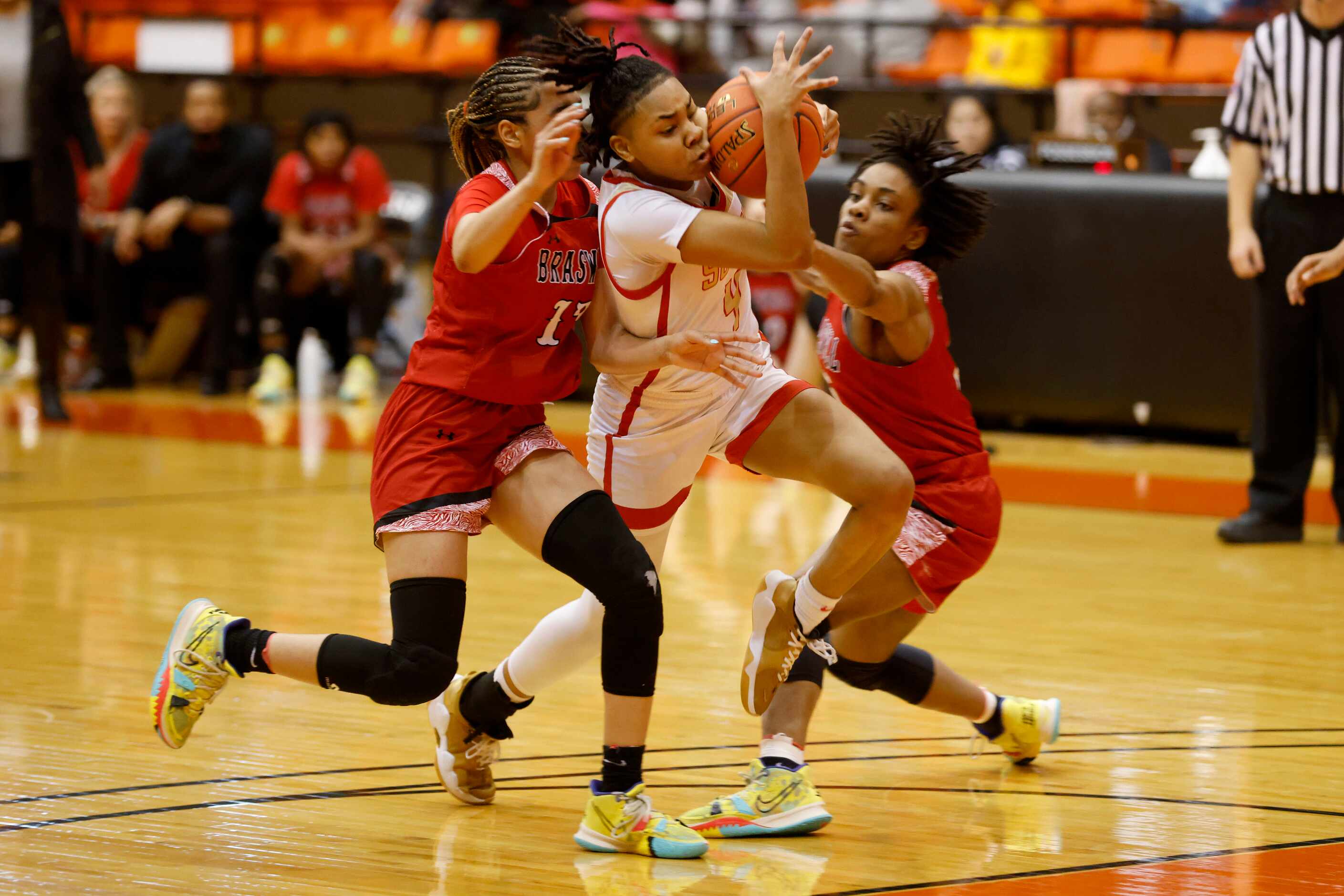 South Grand Prairie’s Joy Madison-Key (4) is fouled while trying to get past Denton Braswell...
