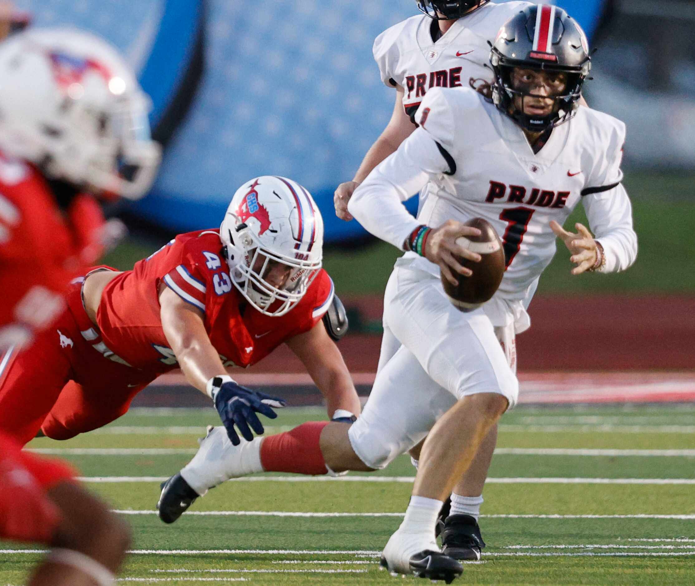 Colleyville Heritage's quarterback Luke Ullrich (1) looks to throw the ball under pressure...