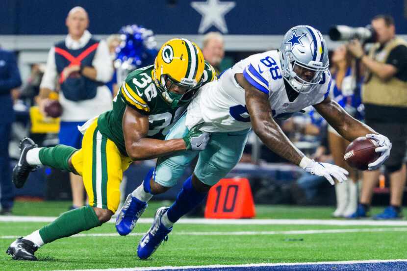 Dallas Cowboys wide receiver Dez Bryant (88) dives over the goal line for a touchdown while...