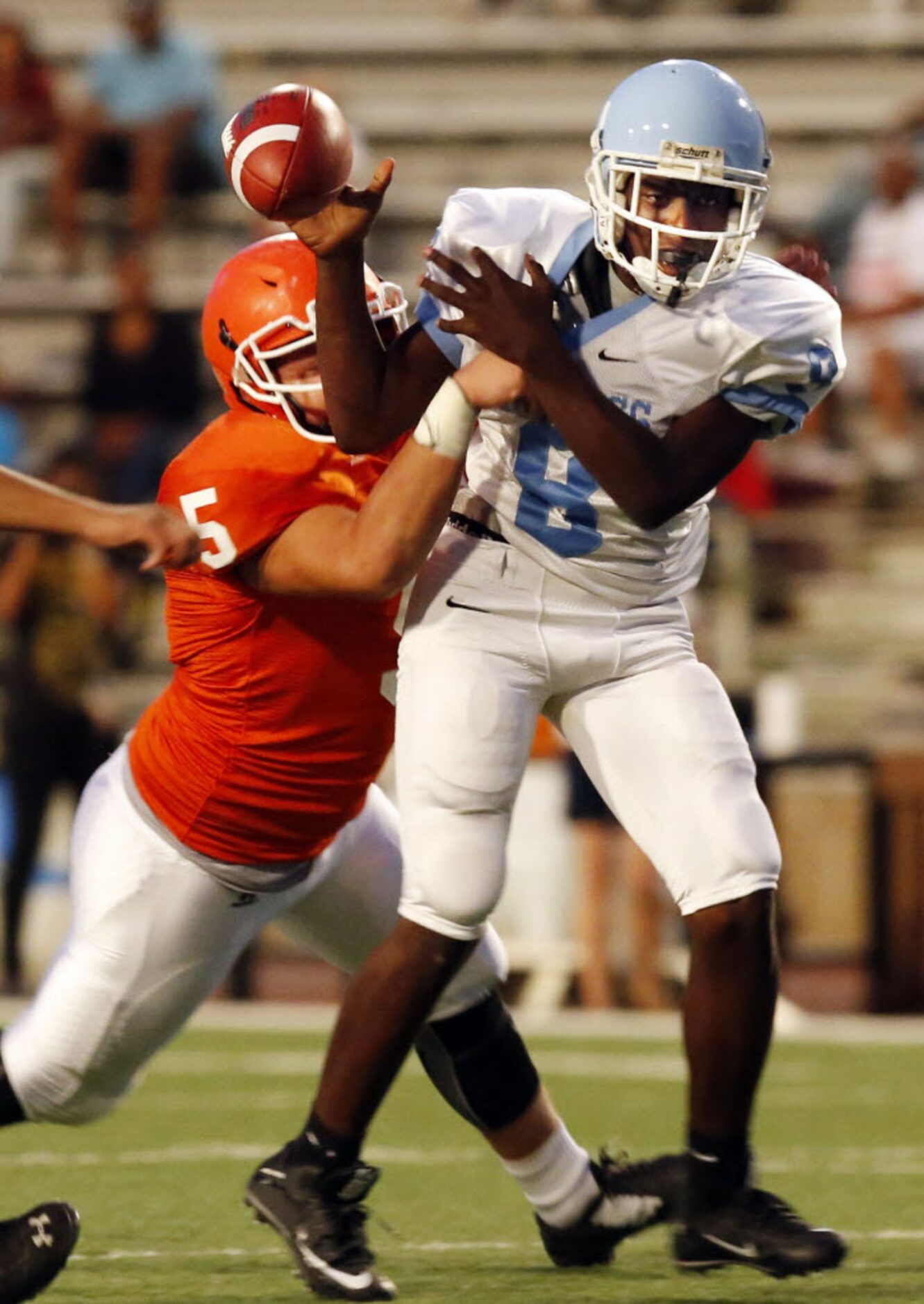 (TXHSFB) North Dallas DE Arnolfo Hernandez (5) hits Roosevelt High QB Victor Parker (8)...