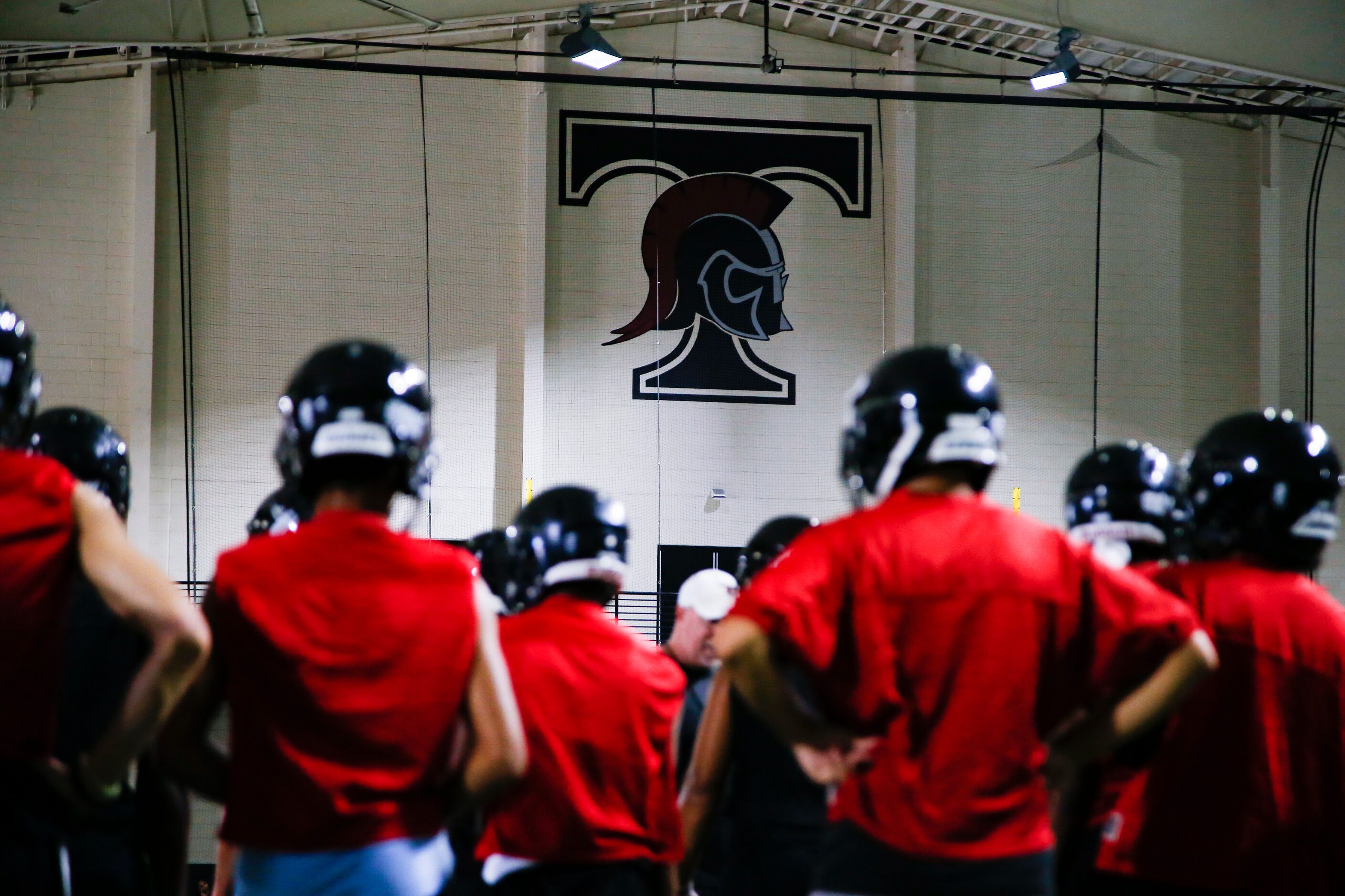 Euless Trinity’s varsity football team runs drills during a practice at Euless Trinity High...