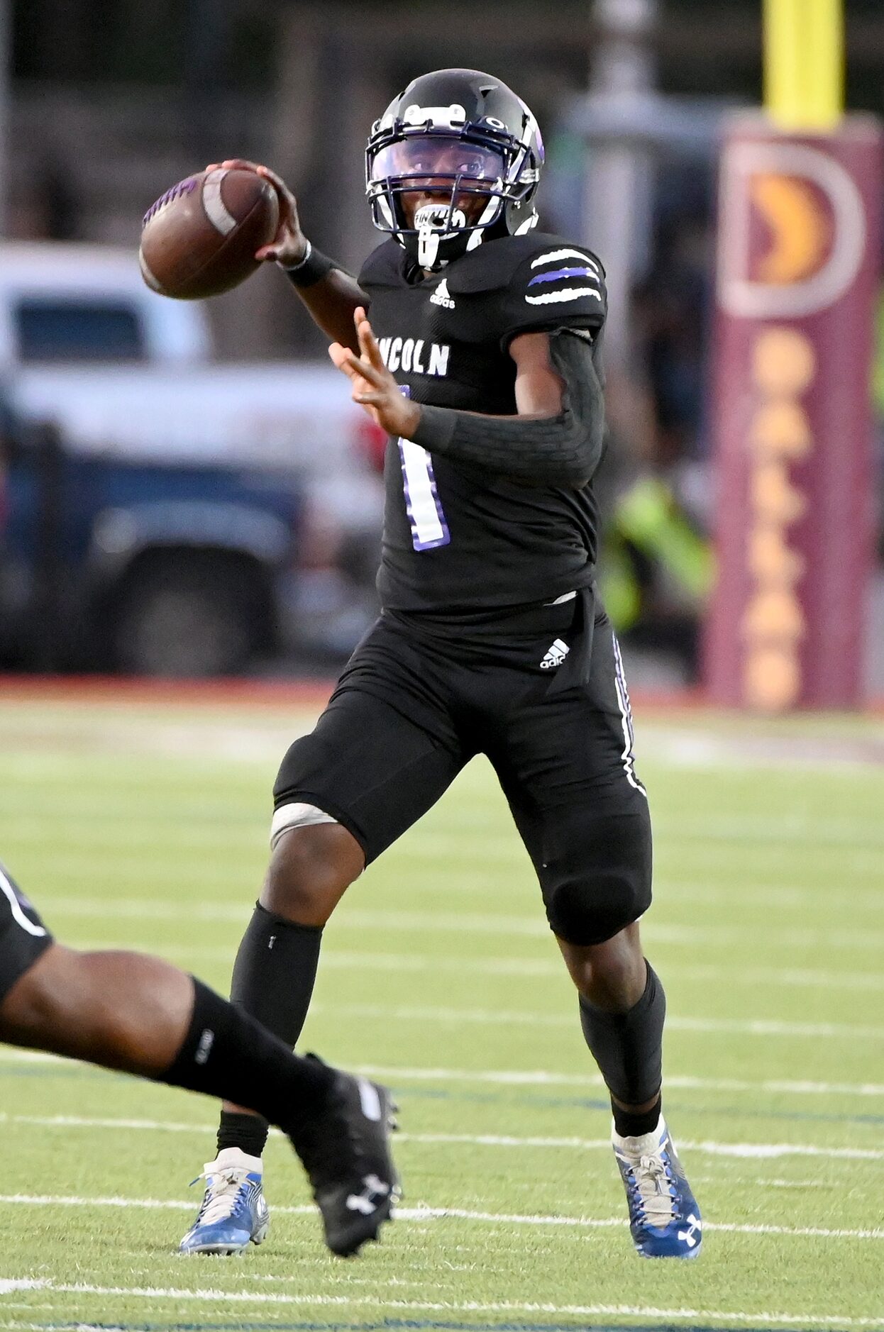 Lincoln’s Byron Eaton Jr. (1) looks to pass in the first half during a high school football...