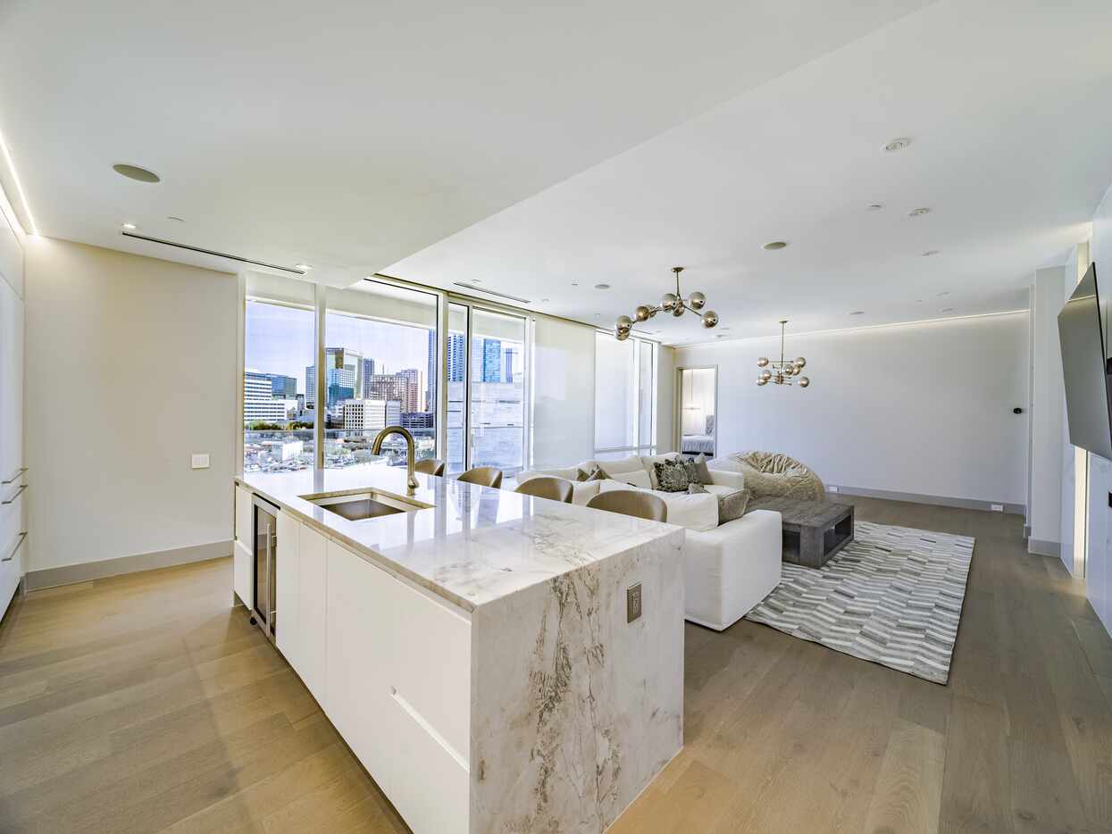 The light, neutral palette and floor-to-ceiling windows create a bright feel in the condo.