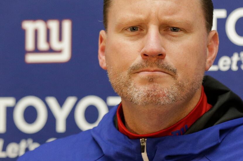 FILE - In this Nov. 24, 2017, file photo, New York Giants head coach Ben McAdoo listens to a...
