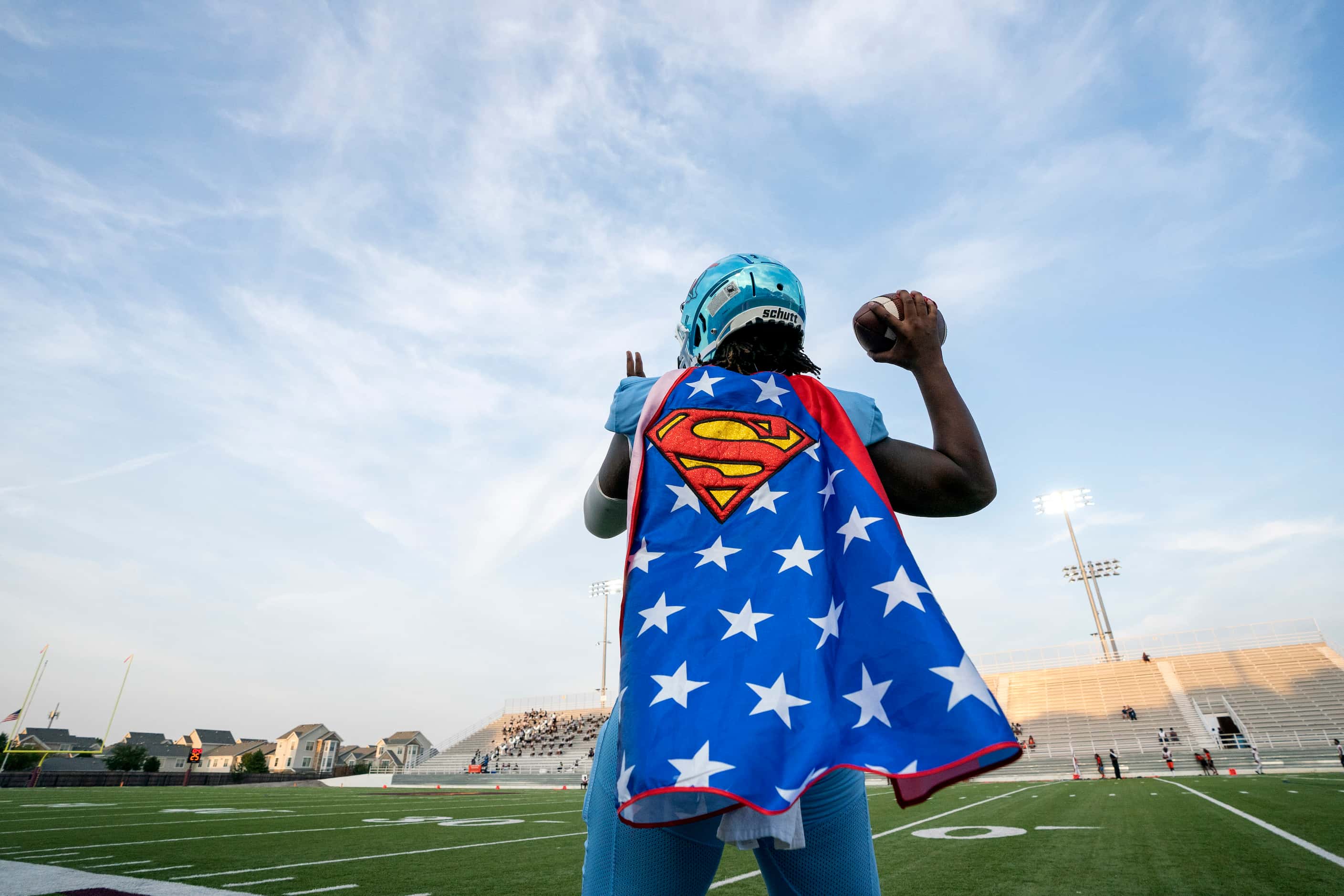 Skyline senior quarterback Darryl Richardson (2) wears a Superman cape as he warms up before...
