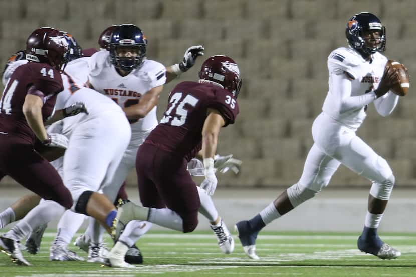 Sachse quarterback Jalen Mayden (4) rolls out in search of an open receiver as Rowlett...
